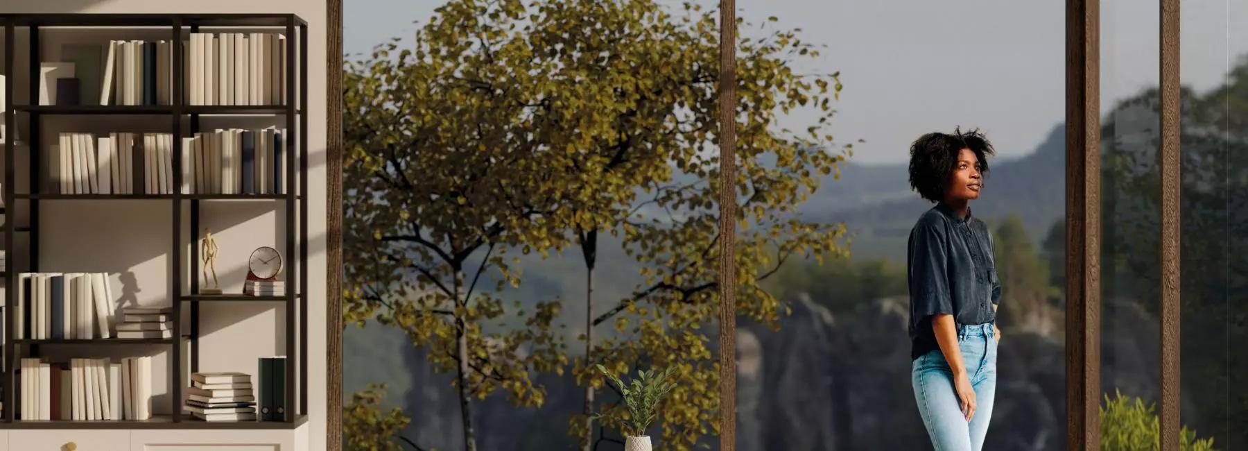 a woman standing in the living room with alrge windows in the background showing a great view of nature. A bookshelf on the right